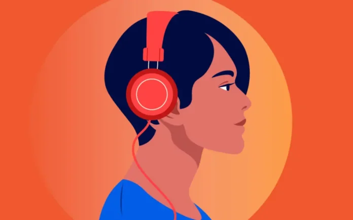 In foto una ragazza che ascolta un audible.